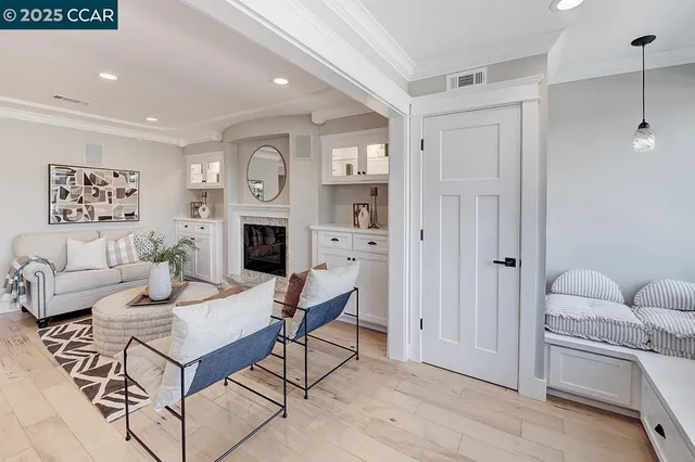 a living room with furniture a fireplace and a table