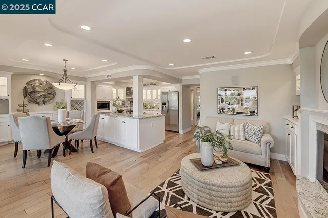 a living room with furniture kitchen and a table