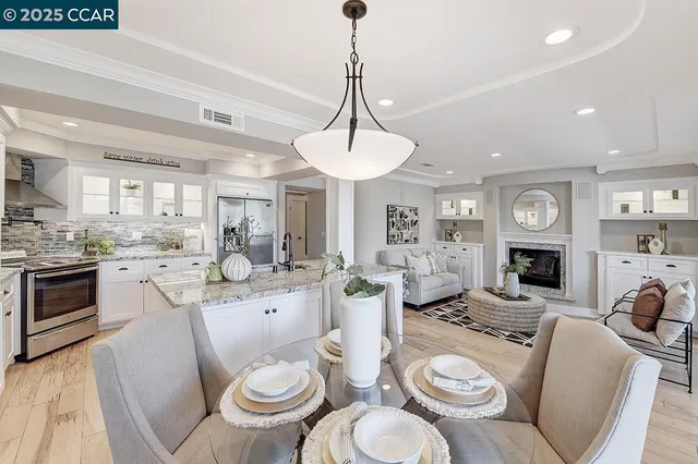 a living room with furniture a fireplace and a chandelier