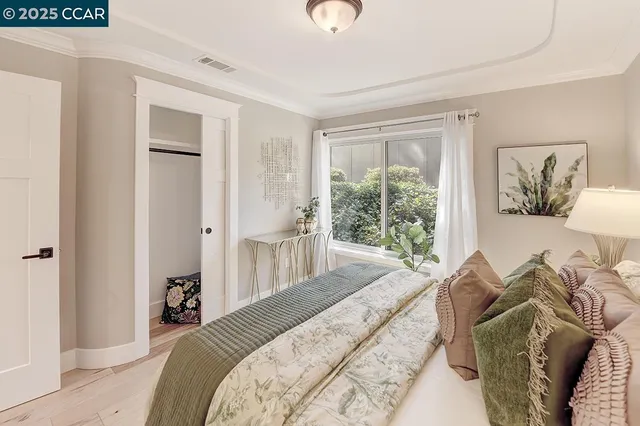 a spacious bedroom with a bed and glass window