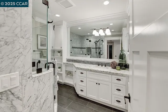 a bathroom with a double vanity sink mirror and double