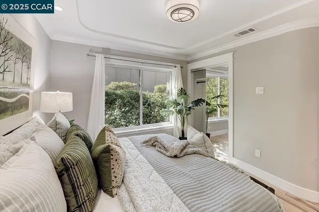 a view of a bedroom with a bed and glass window