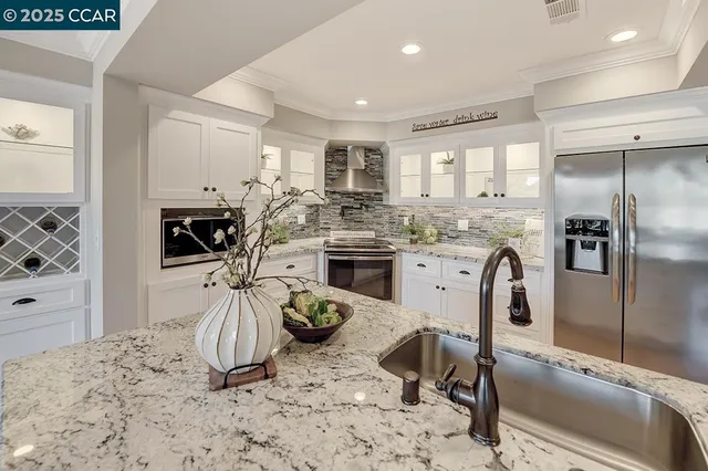 a kitchen with a stove a sink and a refrigerator
