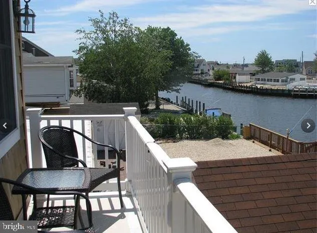 a view of a balcony with furniture and a potted plant