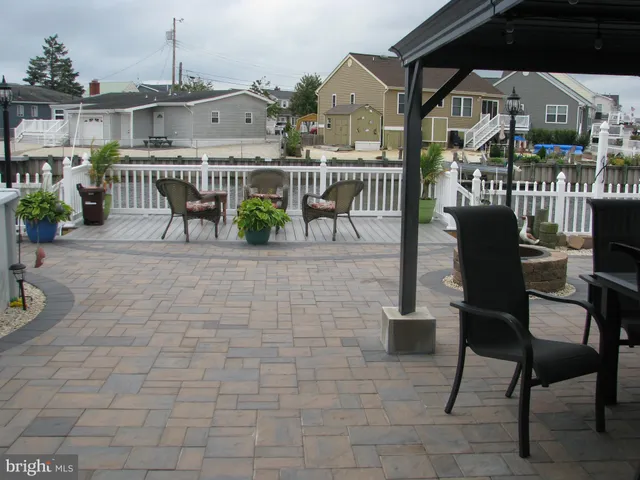 a view of a patio with a dining table and chairs