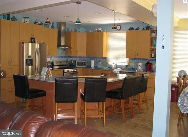 a kitchen with a table chairs sink and cabinets
