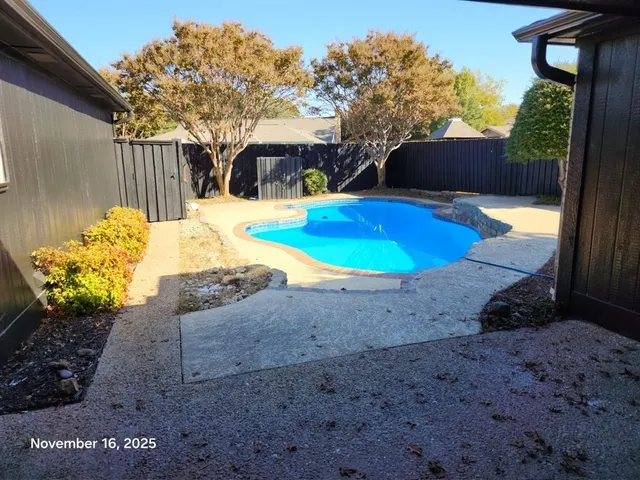 a view of a swimming pool with a patio