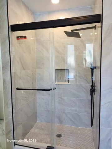 a view with granite countertop wooden floor cabinets and stainless steel appliances