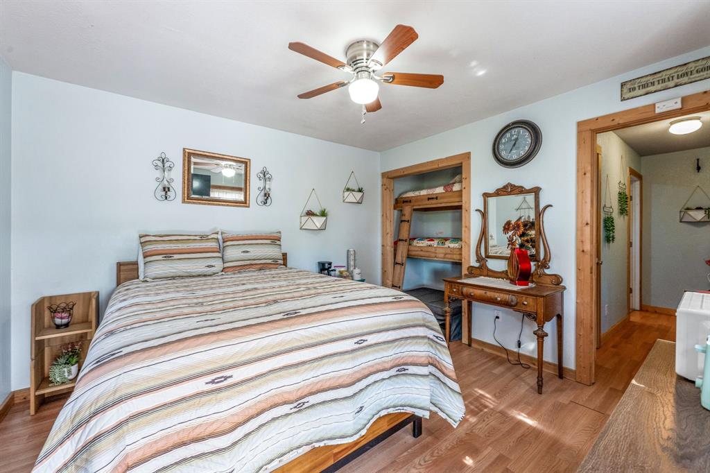 1712 Wells East Road Newcastle, TX 76372 - Photo 12 of 40 a bedroom with bed and wooden floor
