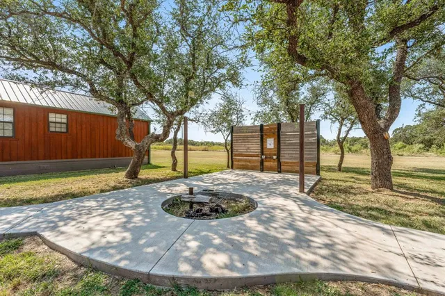 a view of a backyard with large trees