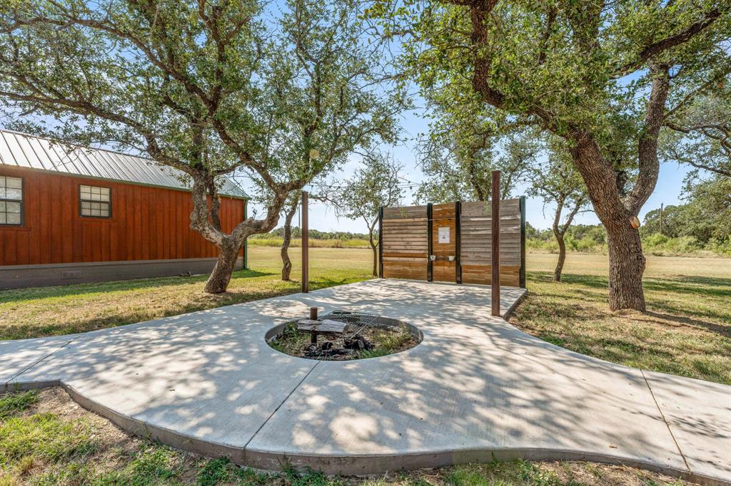 1712 Wells East Road Newcastle, TX 76372 - Photo 14 of 40 a view of a backyard with large trees