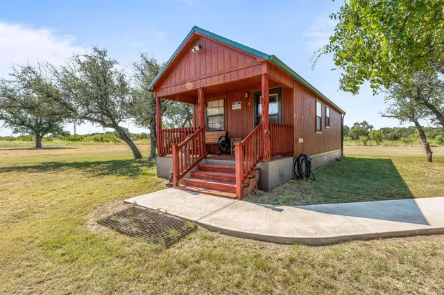 a view of a house with backyard porch and sitting area