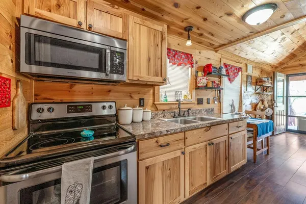 a kitchen with stainless steel appliances granite countertop a stove and a microwave