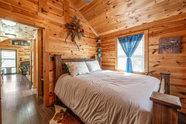 a bed sitting in a bedroom next to a window