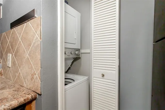 a kitchen with stainless steel appliances granite countertop a sink and a stove