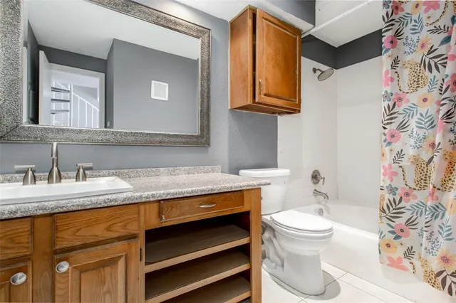 a living room with a large window and furniture