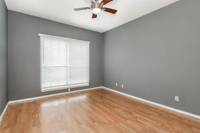 a bathroom with a granite countertop sink and a toilet