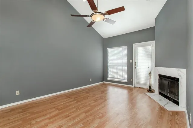wooden floor in an empty room with a fireplace