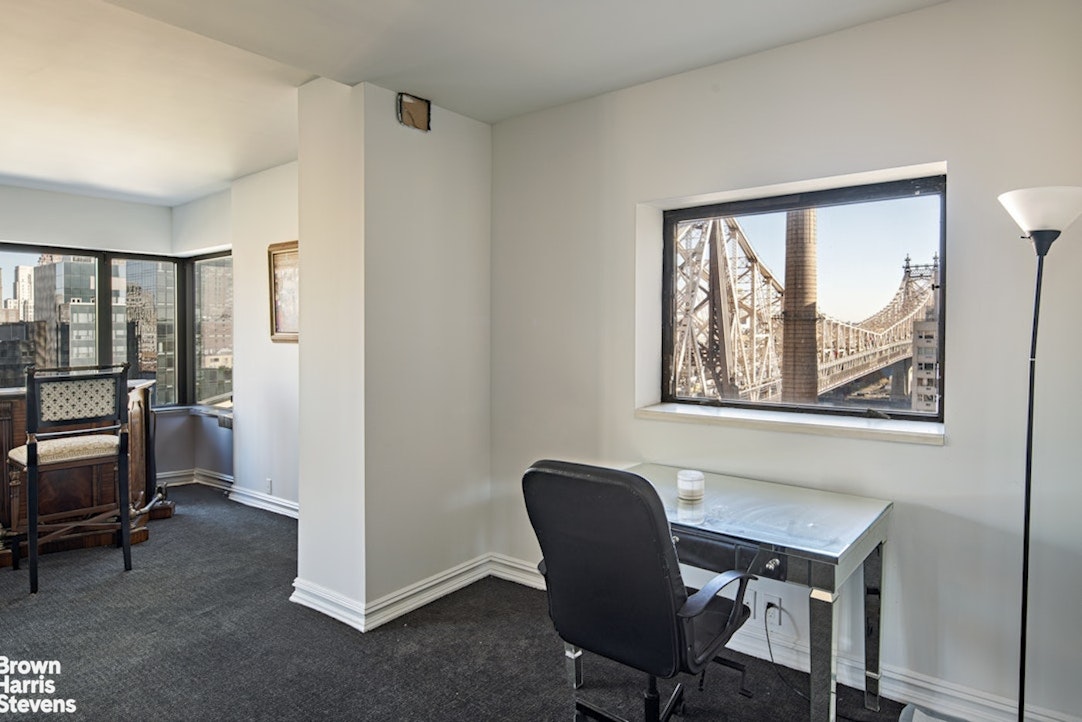 425 East 58th Street, Unit 16AB Manhattan, NY 10022 - Photo 12 of 18 a workspace with furniture and a window