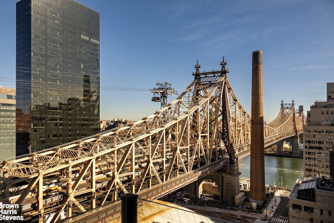 425 East 58th Street, Unit 16AB Manhattan, NY 10022 - Photo 13 of 18 a view of a balcony with an ocean view