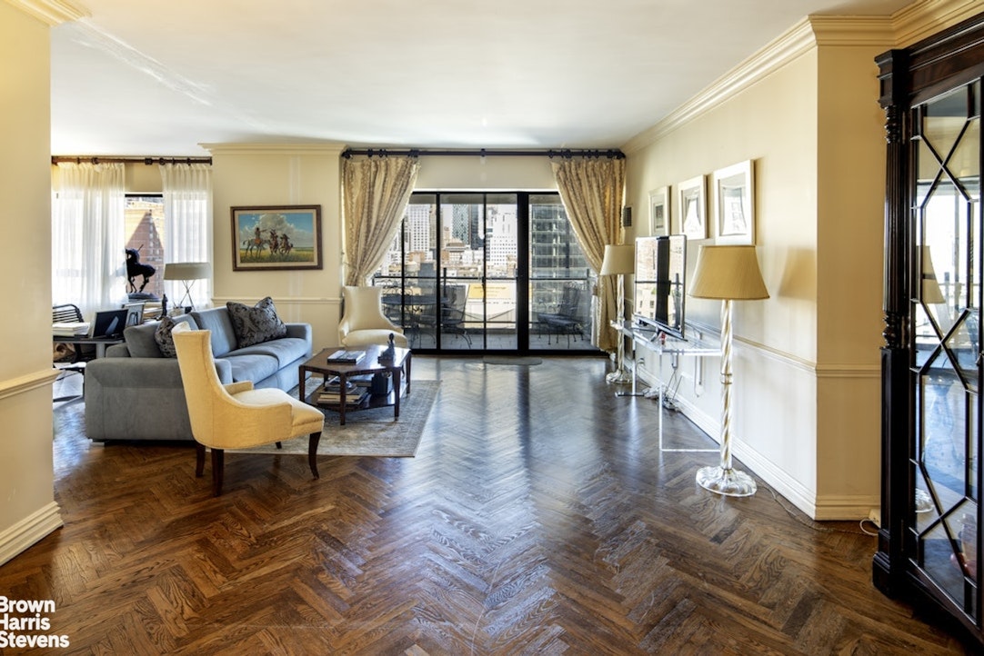 425 East 58th Street, Unit 16AB Manhattan, NY 10022 - Photo 2 of 18 a living room with furniture and a large window