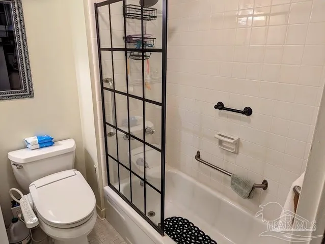 a white toilet sitting next to a bathroom sink
