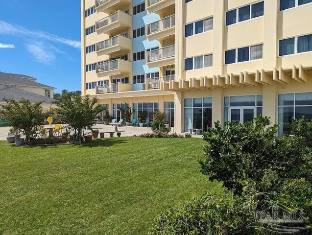 a front view of a building with garden