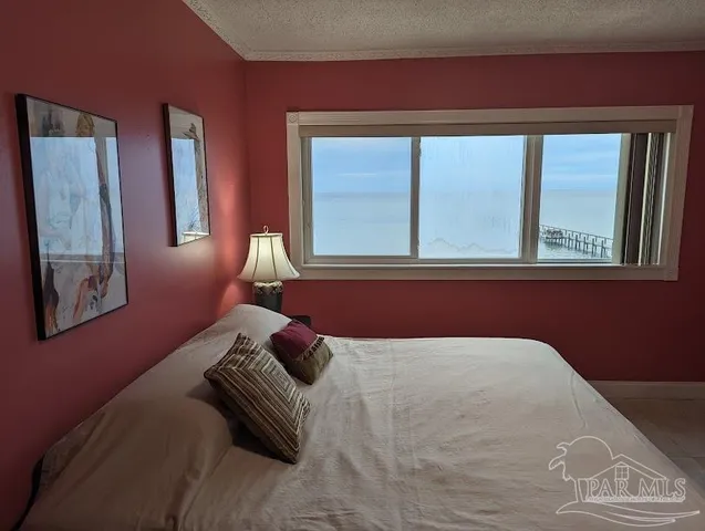 a view of a dining room with furniture large windows and wooden floor
