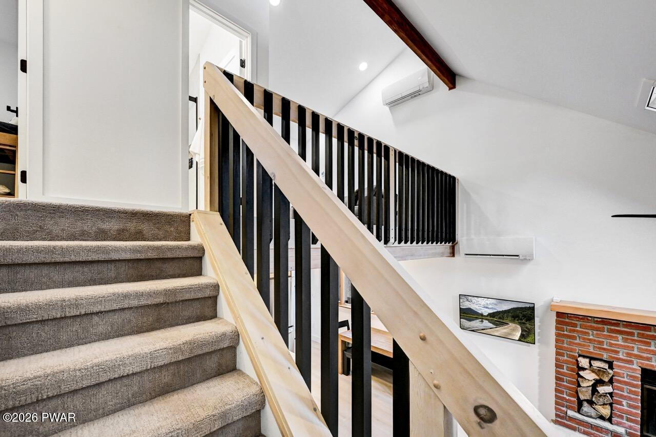 258 Lakeview Road Lackawaxen, PA 18435 - Photo 43 of 119 a view of staircase with lots of frames on wall and windows