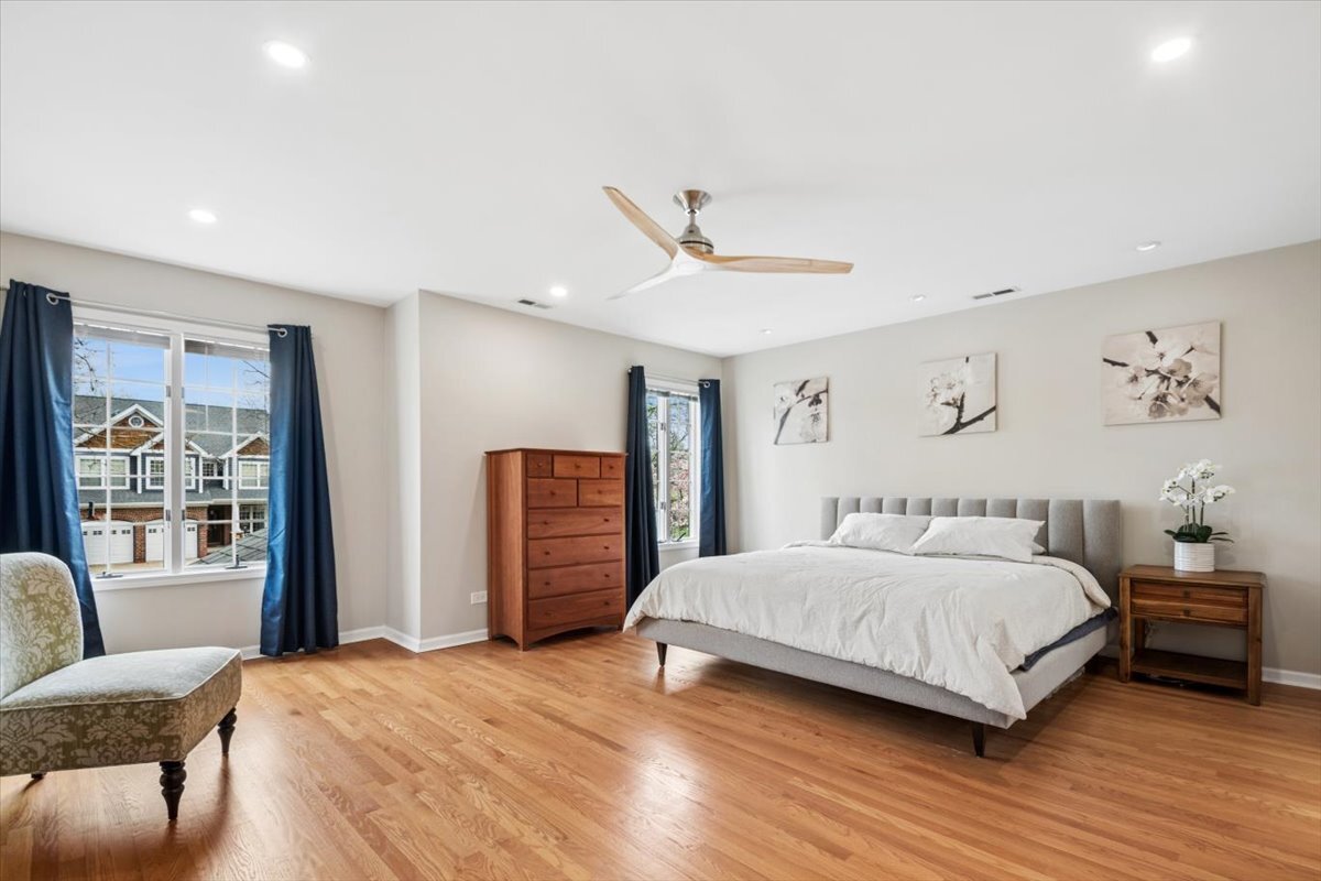 291 Lionel Road Riverside, IL 60546 - Photo 12 of 32 a bedroom with a large bed a chandelier and dresser