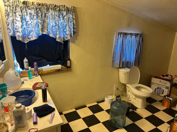 a living room with furniture a flat screen tv and a floor to ceiling window