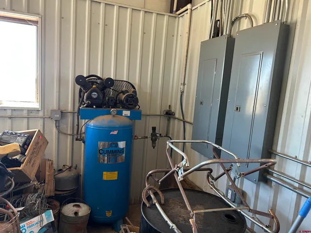 a view of a dry yard with wooden fence