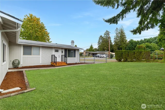 a view of a house with backyard sitting area and garden