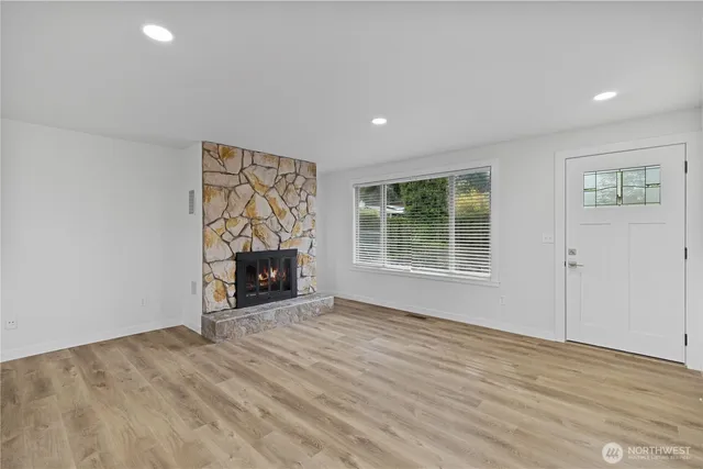 a fireplace with a clock on wall and a fireplace