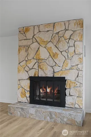 a view of kitchen with granite countertop cabinets and refrigerator
