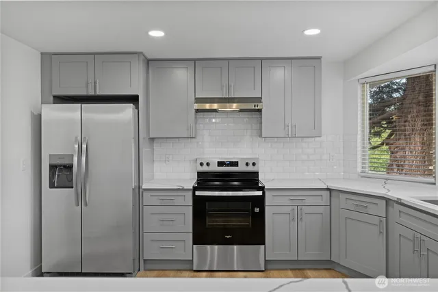 a view of an empty room and wooden floor