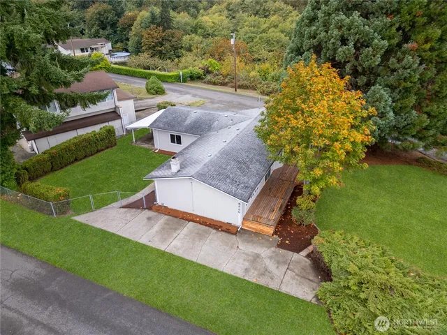a view of backyard with wooden fence