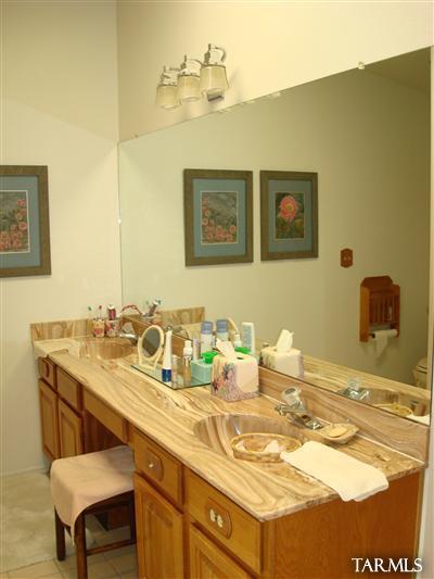 9985 North Desert Sky Road Oro Valley, AZ 85737 - Photo 25 of 43 a bathroom with a sink and a mirror