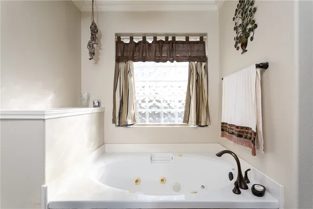 a bathroom with a bathtub and a window
