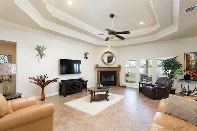 a living room with furniture a fireplace and a flat screen tv