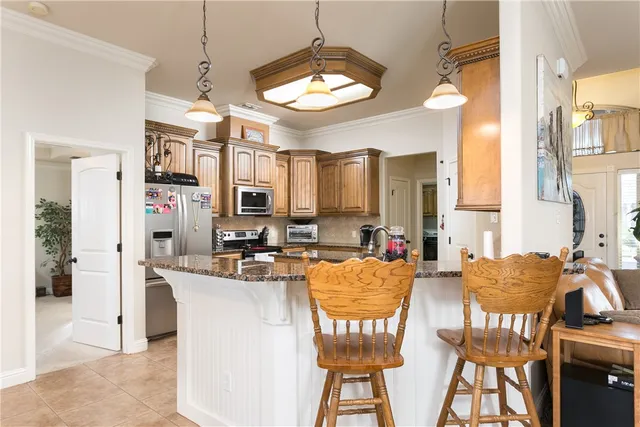 a view of a dining room with furniture and a chandelier