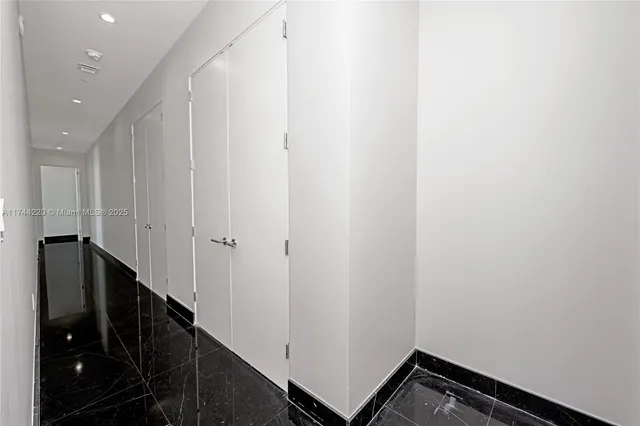 a bathroom with a granite countertop sink a toilet and shower