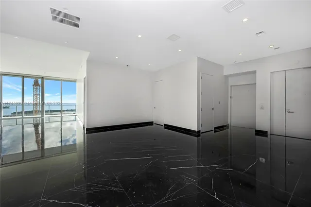 a bathroom with a shower and a glass door
