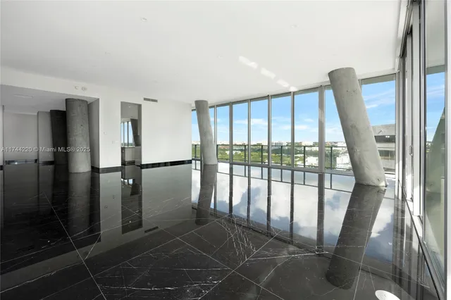 a view of a kitchen with kitchen island granite countertop a large window