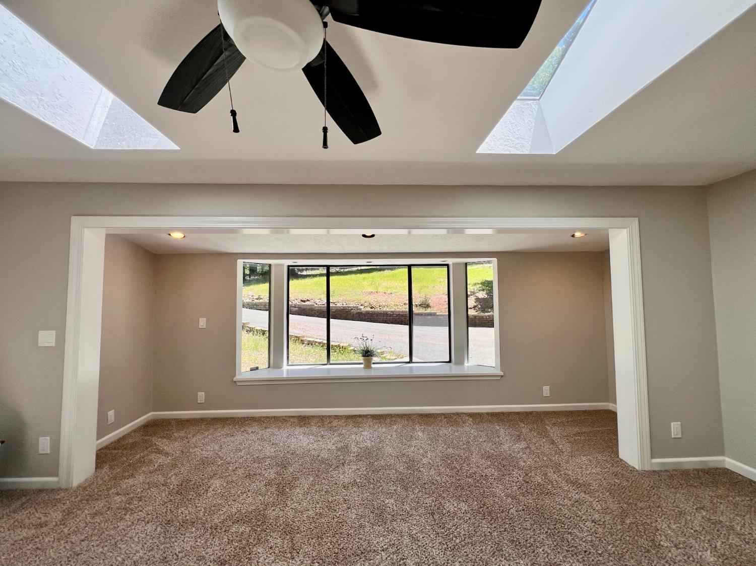 2506 Buffalo Hill Road Georgetown, CA 95634 - Photo 14 of 79 an empty room with windows and ceiling fan