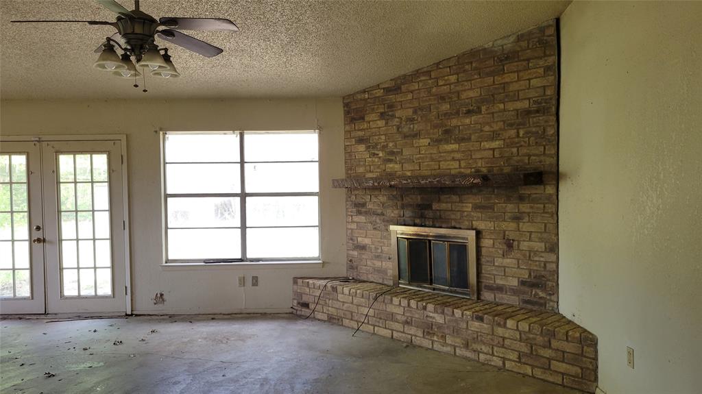 902 South Old Temple Road Hewitt, TX 76643 - Photo 4 of 32 Brick fireplace with hearth and wood mantel