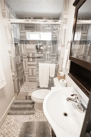 a bathroom with a sink toilet and shower