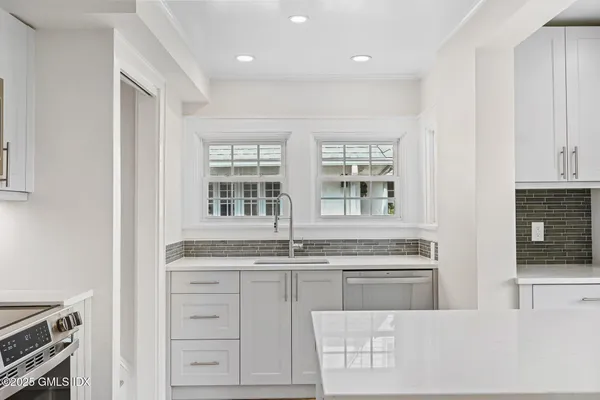a kitchen with cabinets appliances and a counter top space