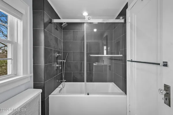 a bathroom with a shower and a tub