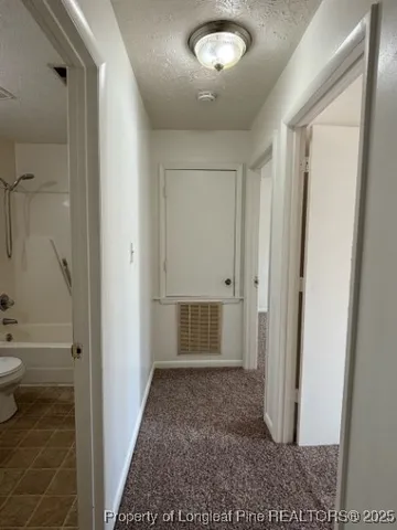 an empty room with wooden floor and mirror